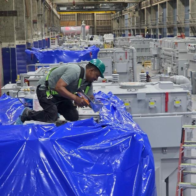 Armstrong technician wrapping a transformer inside a manufacturing facility