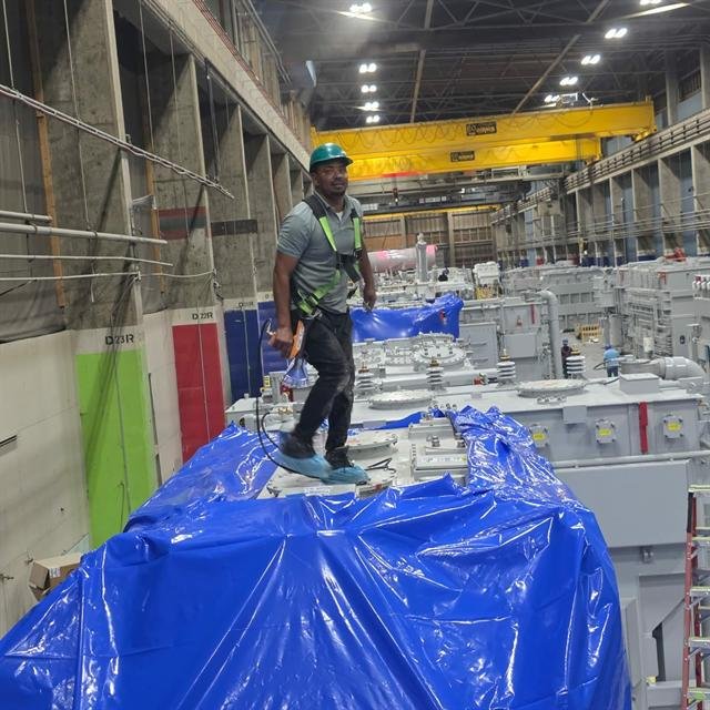 Armstrong crew member welding shrink film seams with a heat gun
